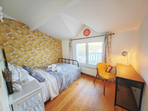 Una cama o camas en una habitación de Comfortable house 45m2, 20 min to Paris with BBQ and shared private garden