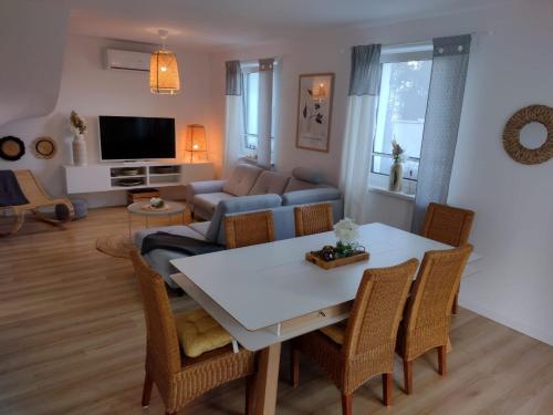 a living room with a table and a couch at Mormin in Dobrojewo