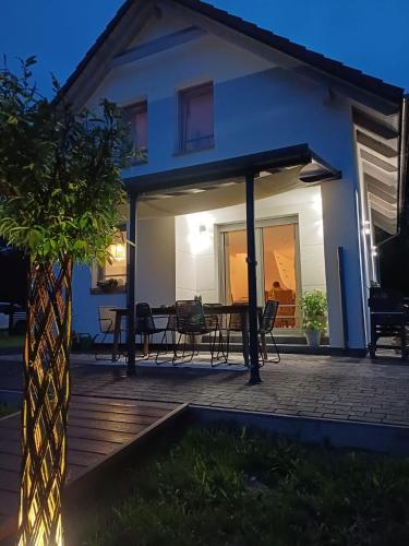 a patio with a table and chairs in front of a house at Mormin in Dobrojewo