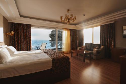 a hotel room with a bed and a view of the ocean at Mr.I Boutique Hotel & Bar in Ohrid