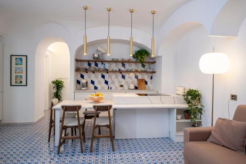 a kitchen with a table and chairs in a room at OraBlu Exclusive Villas in Ischia