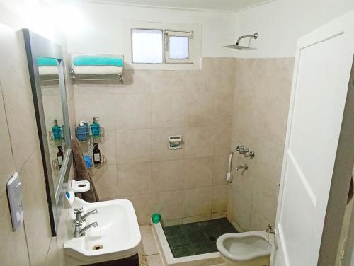 a bathroom with a sink and a toilet at La casita de Manu in Guaymallen