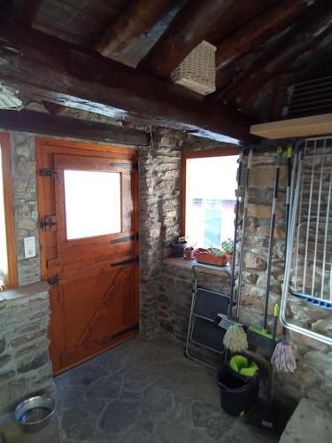 a room with a wooden door and a window at La Borda de Allué in Huesca