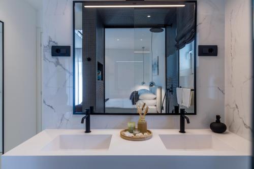 a bathroom with two sinks and a large mirror at Vortex apartments, Opatija Riviera in Matulji