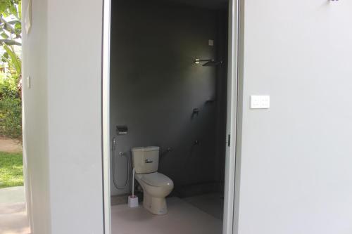 a bathroom with a toilet in a room at Forest Tree Top Holiday Resort in Buttala