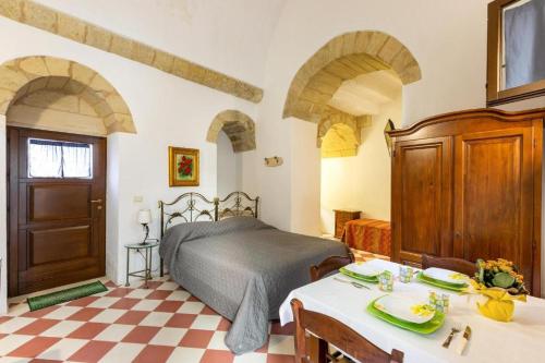 a bedroom with a bed and a table and chairs at L'Antico Palazzo in Vernole