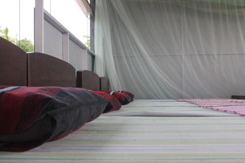 a persons leg laying on the floor of a room at Forest Tree Top Holiday Resort in Buttala