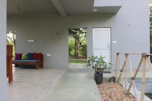 a living room with a couch and a table at Forest Tree Top Holiday Resort in Buttala