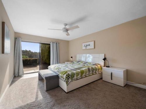 a bedroom with a bed and a large window at Breathtaking views, close to the ocean and canyon in Laguna Niguel