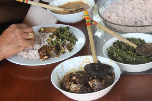 a table topped with bowls of food on a table at Forest Tree Top Holiday Resort in Buttala