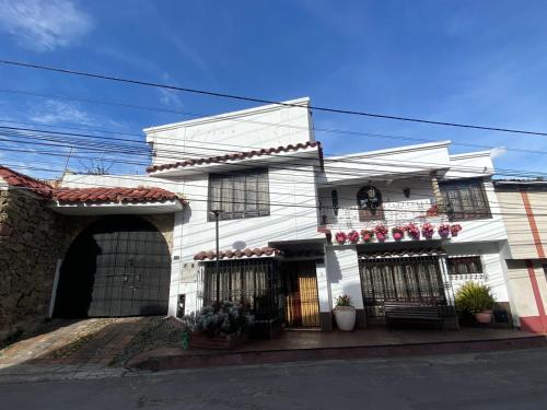 a white building with a store in front of it at Home Mark Casa Boutique in Paipa