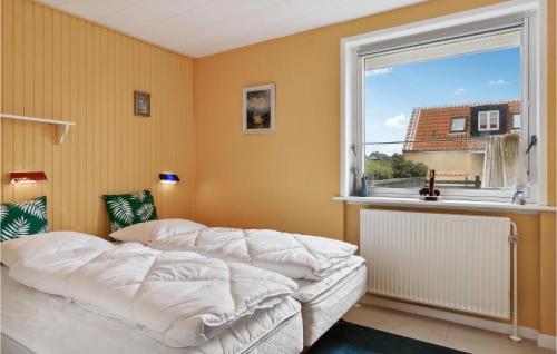 a bedroom with a bed and a large window at 3 Bedroom Stunning Home In Skagen in Skagen