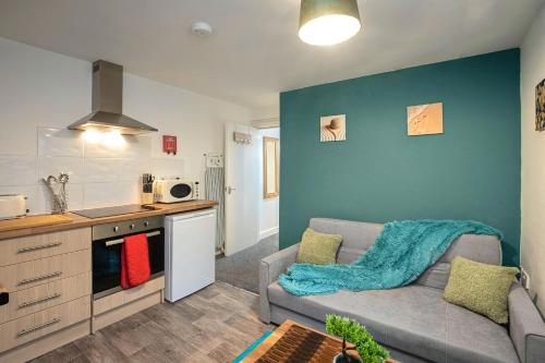 a living room with a couch and a kitchen at Bank Street Apartment 4 in Blackpool