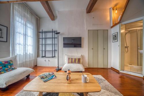 - un salon avec un lit et une table basse dans l'établissement Atypique - Hypercentre / Place aux Herbes, à Grenoble