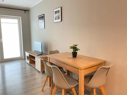 克拉科夫的住宿－Vetulaniego Canary Comfort Apartment，一间带木桌和椅子的用餐室