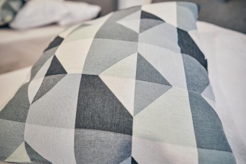 a black and white pillow on a bed at feel... Azores - apartments in Velas