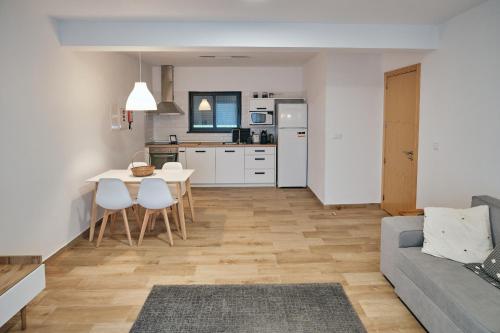 a kitchen and living room with a table and chairs at feel... Azores - apartments in Velas