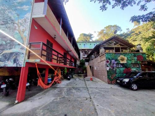 Pousada Naturale في ترينيداد: مبنى احمر فيه كتابات على جانبه