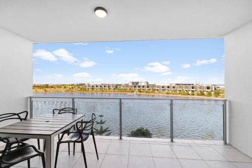 a dining room with a view of the water at North Shore Oceanside Kawana in Kawana Waters