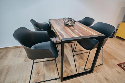 a dining room table with four chairs around it at feel... Azores - apartments in Velas