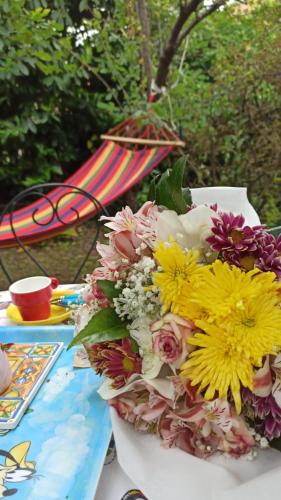 a bouquet of flowers on a table with an umbrella at The Secret Garden Maratea - Casa di Sery in Maratea