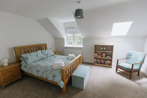 a bedroom with a bed and a chair at BRIARS CLOSE - Four Bed Property on the Edge of the Peak District National Park in Buxton