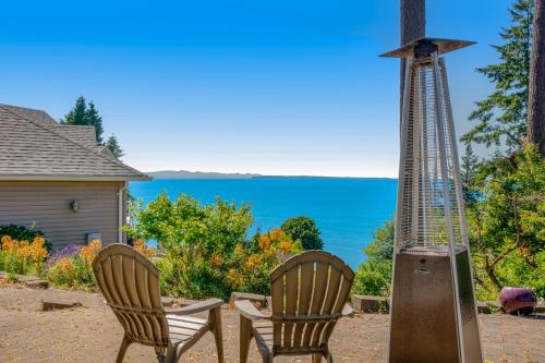 a couple of chairs and a windmill on a patio at Driftwood Retreat in Blaine