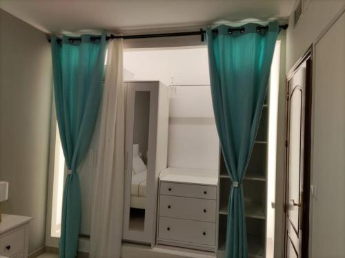 sypialnia z niebieskimi zasłonami i sypialnia z łóżkiem w obiekcie La Casita del Mirador w mieście Baeza