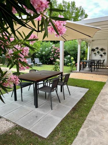 a picnic table and chairs under an umbrella at Agriturismo Basegò in Venice