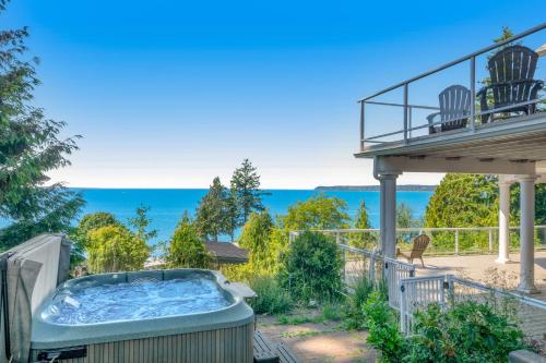 a hot tub on the patio of a house at Driftwood Retreat in Blaine