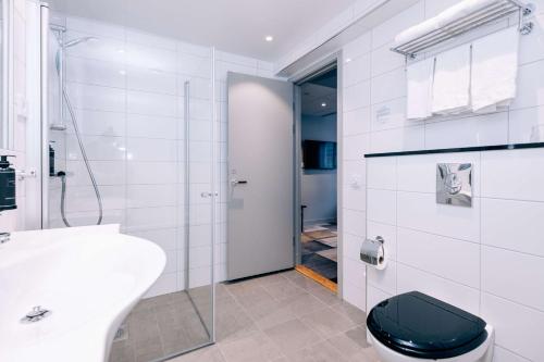 a bathroom with a toilet and a sink and a shower at Best Western Plus JA Hotel Karlskrona in Karlskrona