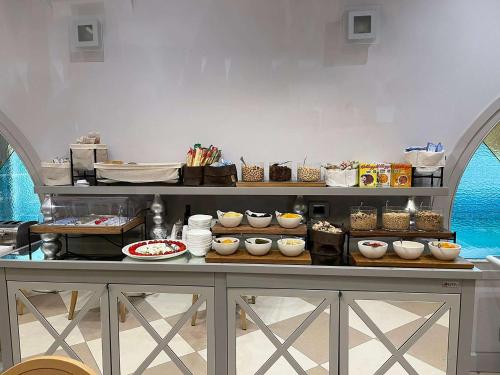 a buffet with bowls and other food on a table at Hotel Centrale Best Western Signature Collection in Tirano
