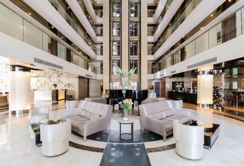 a lobby with couches and chairs in a building at The Sanctuary Resort Pattaya, BW Signature Collection in Pattaya South
