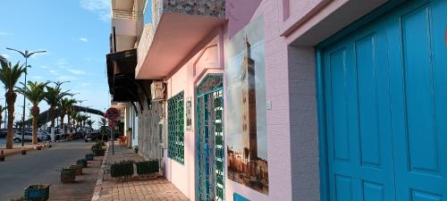 a building with colorful tile on the side of a street at SULTANA Beach Riad in Saidia 