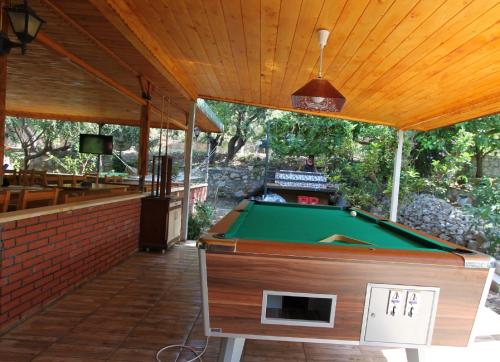 a pool table in a patio with awning and a pool table at Elly's Home in Mesudiye