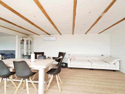 a dining room with a table and chairs and a couch at 4 person holiday home in Slagelse-By Traum in Slagelse
