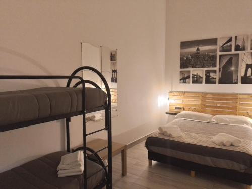 a bedroom with two bunk beds and a desk at LA CASA DEL RIONE SANITA’ in Naples