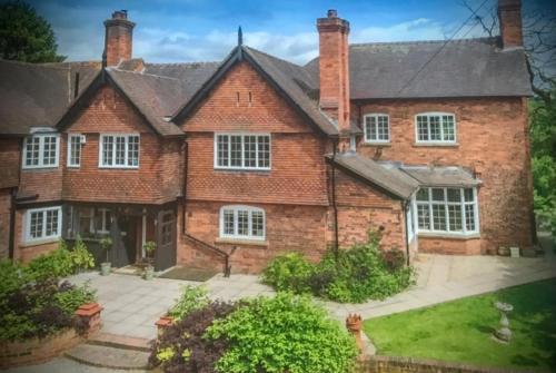 a large brick house with white windows at The Old Rectory - Valley View Room In Private Home in Stockton on Teme
