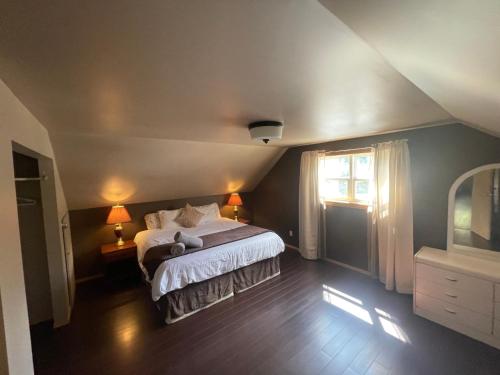 a bedroom with a bed and a window at Blaeberry Valley Vacation Rentals in Golden