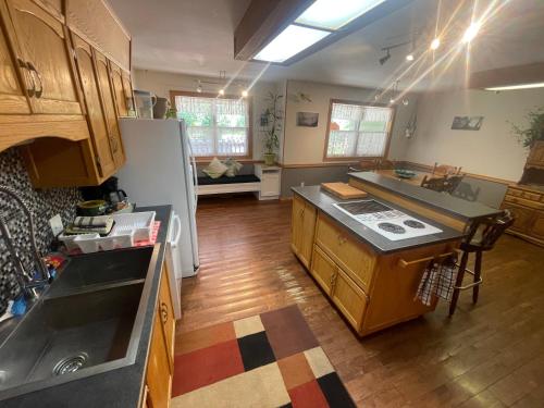 a kitchen with a sink and a refrigerator at Blaeberry Valley Vacation Rentals in Golden