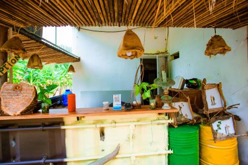 a kitchen with a table and a counter with buckets at Phong Nha A Little Leaf Homestay in Phong Nha