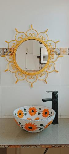 a bathroom sink with a large mirror on the wall at Riad SULTANA lateral seaview in Saidia 