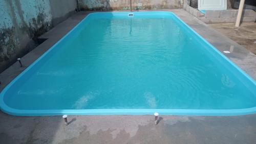 uma grande piscina azul num quintal em Casa na Serra. Negócios ou lazer em Serra