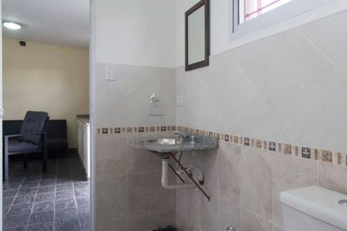 a bathroom with a sink and a mirror at Del Fundador in San Luis