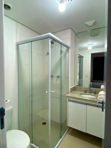 a bathroom with a glass shower and a toilet at Studio APaulistana56 in Sao Paulo