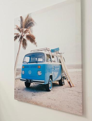 a blue van parked on the beach with a surfboard at Blue house 1ª linea playa in Torrevieja