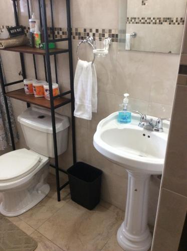 a bathroom with a toilet and a sink at Le Quad - One Bedroom & Studio Apt - Private, Spacious & Secured in Kingston