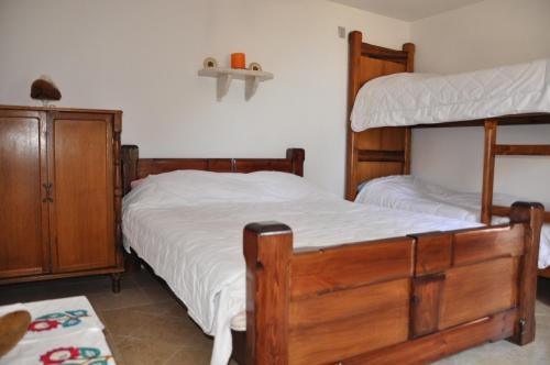 a bedroom with two bunk beds and a dresser at Secluded holiday house Stokic Pod, Velebit - 21524 in Jablanac