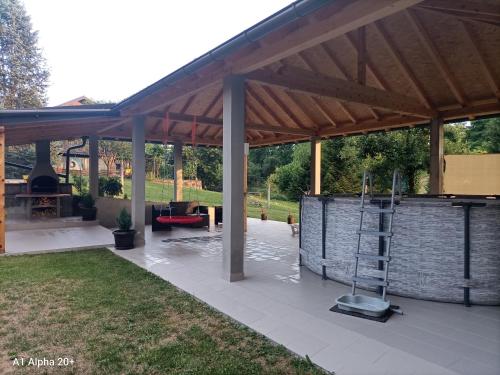 a pavilion with an outdoor kitchen and a grill at Family friendly house with a swimming pool Mihalic Selo, Karlovac - 20284 in Duga Resa