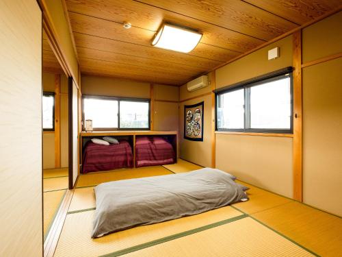 een kleine kamer met een bed in het midden bij Yanagi-an in Kameoka